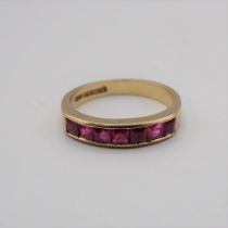 A Ruby half Eternity Ring channel-set baguettes in 18ct gold, ring size L 1/2, approx 3.70gms