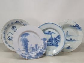 Four Antique Delft blue and white Plates with painted landscapes, figures, etc.