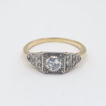 A Diamond Ring millegrain-set brilliant-cut stone with further stones to shoulders, ring size O 1/2,