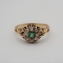 An Emerald and Diamond Cluster Ring pavé-set step-cut emerald within a frame of old-cut diamonds