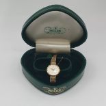 A lady's Rolex Precision Wristwatch the white dial with hourly baton markers in 9ct gold case on 9ct