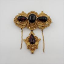 A Victorian gilt metal filigree Brooch set foil backed red paste with detachable drop