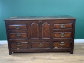 An antique oak Mule Chest with hinged cover, above four dummy and three real drawer below, 5ft 1in