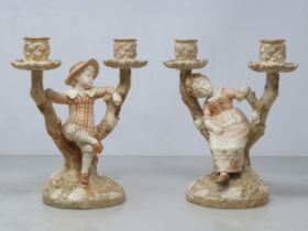 A pair of Royal Worcester Hadley two branch blush Candelabra with figures of boy and girl on