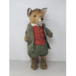 A Steiff Fox in green Jacket, Pantaloons and red Waistcoat with button in ear 14 1/2in H