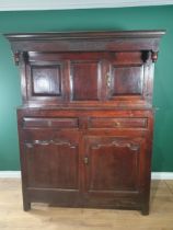 An 18th C Oak Deuddarn the upper frieze carved IMI 1746 above a pair of cupboard doors, the base