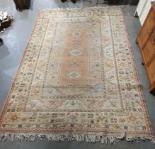 A Turkish Carpet of multi-bordered design and having three central lozenges on a red ground 12ft 1in