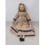 An antique folk art Peg Doll with painted facial features, hands and legs in traditional rustic