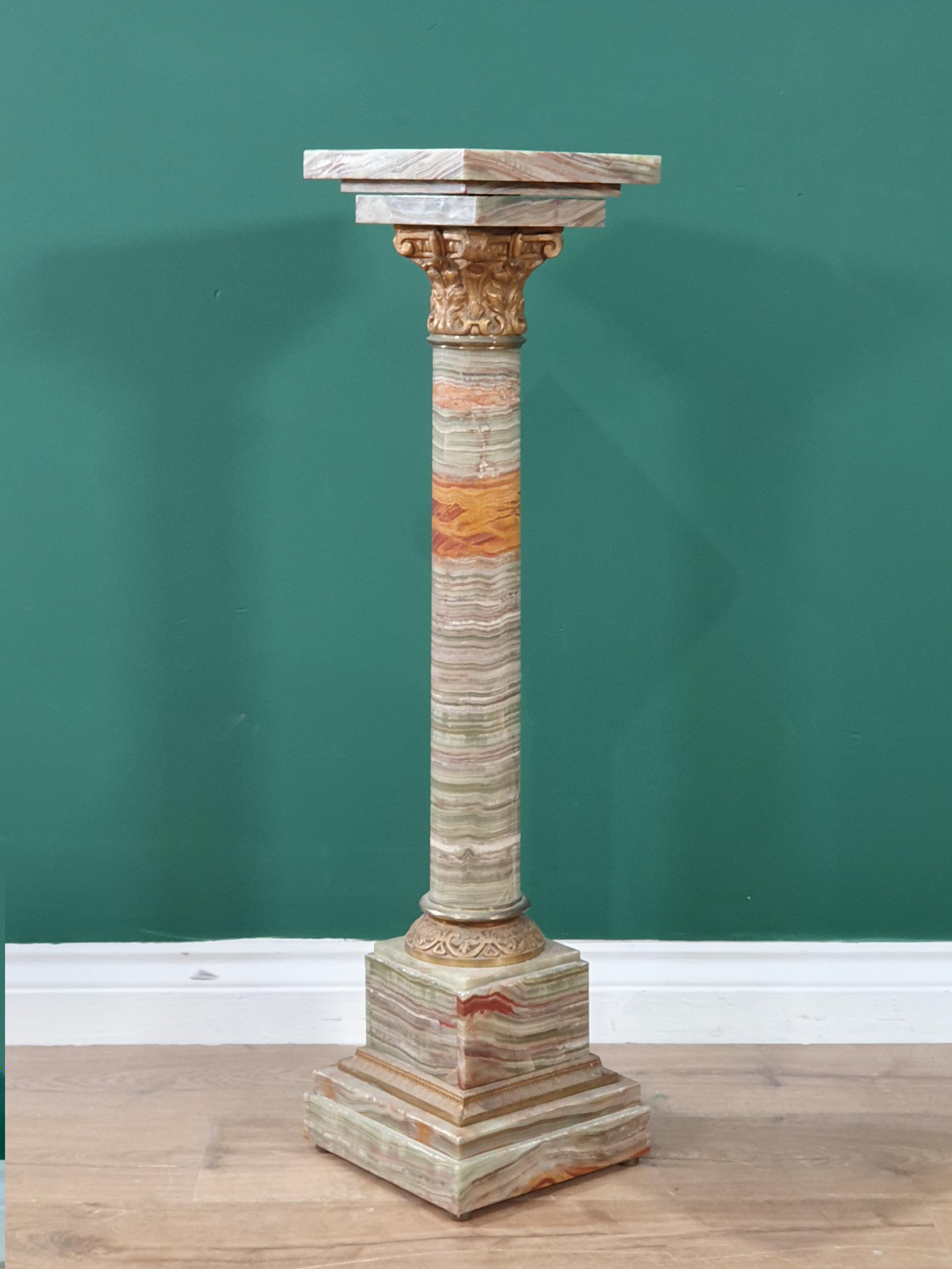 A green and variegated marble Pedestal with square top on cylindrical column, gilt metal capital and