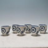 Six Caughley blue and white Coffee Cups decorated floral sprays with ring of flowers and floral