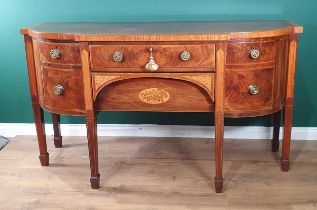 A George III mahogany Breakfront Sideboard, crossbanded in satinwood fitted central drawer above a