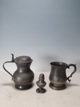 A pewter lidded Baluster Tankard with a shaped thumb rest and handle, marked London, 7 in High,