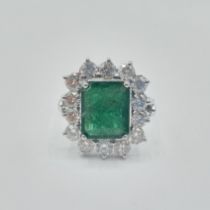 An Emerald and Diamond Cluster Ring corner claw-set step-cut emerald, approx 10.10mm x 8.40mm,