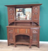 An oak Art Nouveau Mirrorback Sideboard, the upper section with a pair of inlaid doors, the base