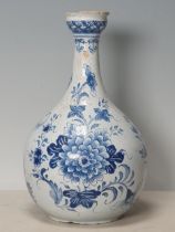 A blue and white Delft Bottle Shaped Vase with all over Floral designs (Rim Chipped) 9.5" High.