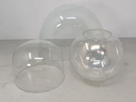 An antique oval glass Dome 10in W x 7 1/2in H, a circular glass Dome 6in D x 5in H and a Goldfish