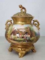 A Royal Worcester Pot Pourri and cover with gilt branch moulded handles, painted a cottage scene,