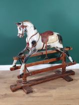 A painted and carved wooden Rocking Horse by Lines Bros for Triang with mane (lacks tail), saddle