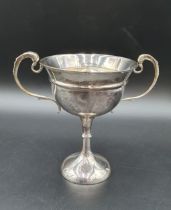 A George V silver two handled Trophy with presentation inscription on single knop stem, London 1928,
