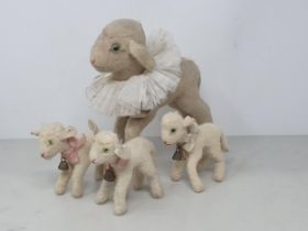 A vintage Steiff Lamb 8 1/2in H and three smaller Lambs including two with card name tags 'Lamby'