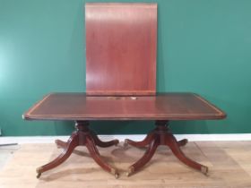 A mahogany twin pillar Dining Table with crossbanded top, with baluster pillars on quadruple