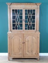 A Regency pine Bookcase with swag moulded frieze fitted pair of astragal glazed doors between