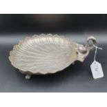 A Continental silver scallop shape Dish with dolphin handle on three scroll supports