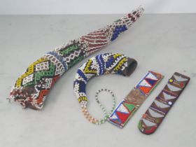 Two Zulu or Ndebele beadwork covered Horns, a Masai beadwork Ear Ornament and another Masai