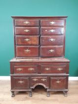 An 18th Century oak Chest on Stand with an usual arrangement of four short drawers and a cupboard