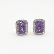 A pair of Amethyst and Diamond Cluster Earrings each corner claw-set step-cut amethyst within a