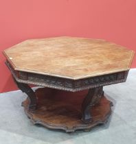 A Victorian Continental oak octagonal Centre Table with moulded edge, with carved frieze, raised