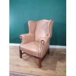 A Georgian style Wingback Library Chair with studded detail and raised on moulded squared front