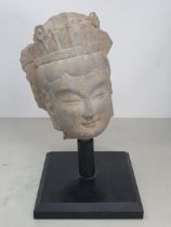 A carved stone Buddha Head A/F, on associated black painted stand, 1ft 1"High.