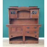 An Arts and Crafts oak Dresser, the upper section fitted a pair of glazed door, the lower section