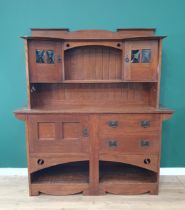 An Arts and Crafts oak Dresser, the upper section fitted a pair of glazed door, the lower section