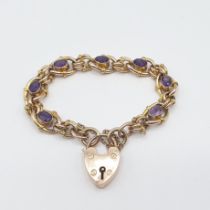 An Amethyst Bracelet rubover-set seven oval-cut stones in fancy link chain on padlock fastener in