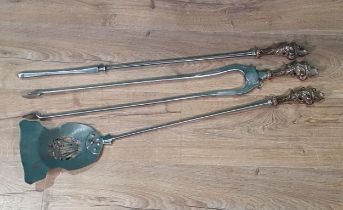 A set of three Georgian polished steel Fire Implements with scrolled brass handles, plain stems