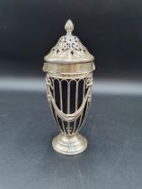 An Edward VII silver Sugar Caster of urn shape decorated ribbons and swags, spiral finial, blue