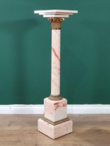 A pink variegated marble Pedestal with square top on cylindrical column with gilt metal capital on