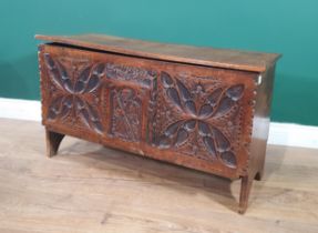 A small carved oak Plank Chest with hinged cover and carved figure to the front, 2ft 8in W
