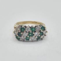 An Emerald and Diamond Cluster Ring peg-set three rows of alternating round emeralds and brilliant-