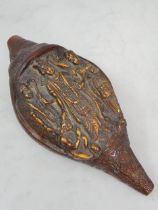 An Oriental patinated bronze Deity Shell with scrolled and floral decorations, with four Religious