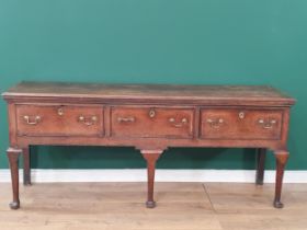 An 18th century oak Dresser Base having cross-banded top above three cross-banded drawers on three