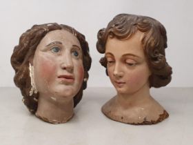 Two French 19th Century carved and plaster Heads of angels with painted hair and facial details