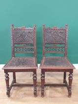 A pair of 19th Century carved oak Hall Chairs with finely carved lion mask finials, tooled and