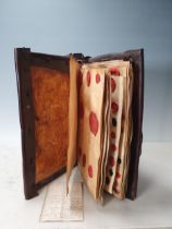 A leather bound Book of historical seals, and a list of the names of the families