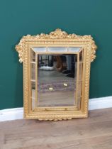 A gilt framed Wall Mirror, the central raised bevelled plate surrounded by small mirror panels and