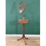 An Edwardian mahogany Shaving Stand with shield-shaped bevelled mirror mounted on hexagonal two