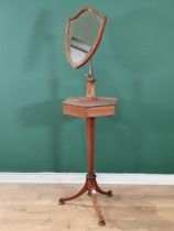 An Edwardian mahogany Shaving Stand with shield-shaped bevelled mirror mounted on hexagonal two