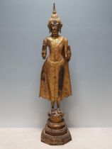 A 19th Century gilt bronze Figure of a Buddha, wearing robes with all over floral/star
